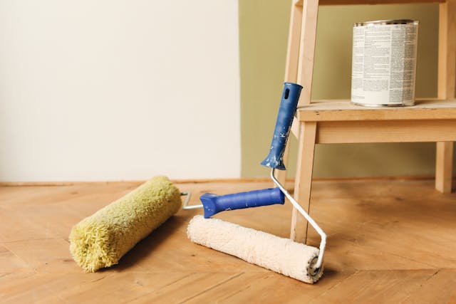 Paint rollers on a wooden floor