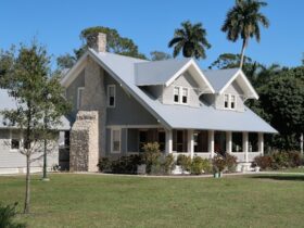 brown and white concrete house near green grass field during daytime