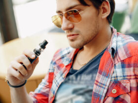 man sitting in a cafe with vape